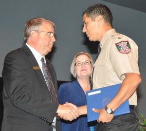 Graduate Felix Moros with SFSC Trustees Timothy Backer and Kris Rider