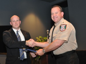 Cadet James S. Sottile accepting his diploma from Michael Huften, SFSC’s coordinator of criminal justice training.