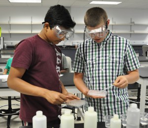 Students collect acid solutions during one of SFSC’s STEMQuest classes.