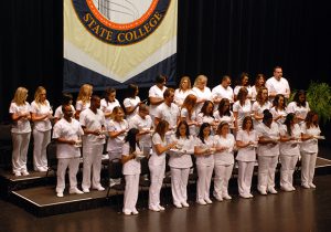 Nursing Graduates Light Candles on their Nightingale Lamps