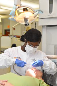 Dental student checking out a patient