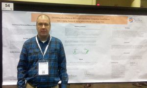 Carl Ewing with research project results poster at the conference