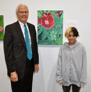 Dr. Thomas Leitzel (left) and Caitlin Cruz with "Red Flowers"