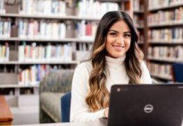 Female student with laptop in library