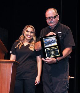 Deborah Figueroa presents a plaque to Bob Sconyers