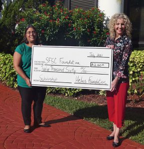 Tina Stetson and Jamie Bateman with big check