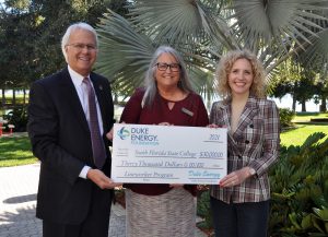 Dr. Thomas C. Leitzel (left), Nancy Dodd, and Jamie Bateman with check