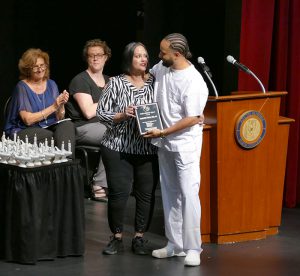 A.J. Gall presents the Golden D.U.C.K. award to Marlene Cruz.