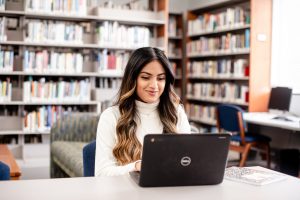 Female student with laptop at the library