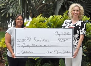 Tina Stetson and Jamie Bateman holding a big check