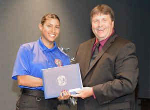 Sabrina Valero, leader of Basic Law Enforcement Academy 270, receives an award for having the highest firearms score from SFSC Criminal Justice Programs Coordinator Joseph Marble.
