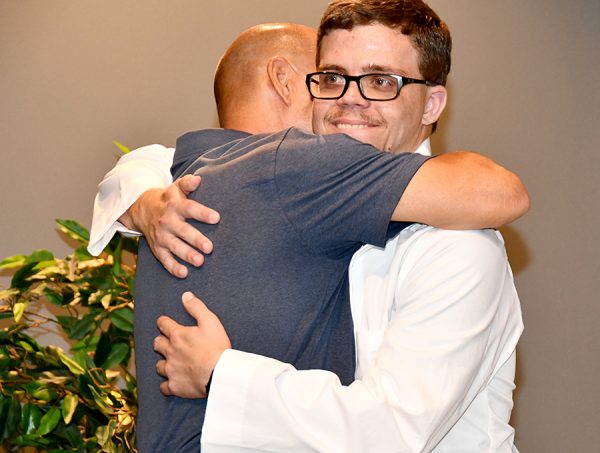 Zackary Taylor gets a hug from his dad for graduating from the SFSC Radiography program. It took two years for Taylor and his classmates to earn their Associate in Science degree in Radiography.