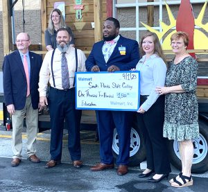 Terry Cascoe, Walmart Wauchula store manager, presents SFSC representatives with a check for $1,500.