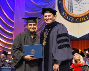 President Fred Hawkins with graduate