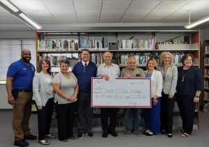 Group on DeSoto Campus with donation check