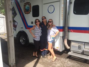 Heidi Bates Arnold and Family beside an ambulance.