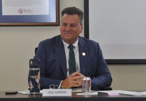 President Fred Hawkins at the Board Meeting with a nameplate in front of him that says Fred Hawkins.