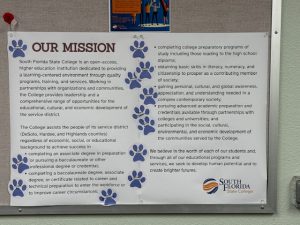 Two posters with paw print stickers all over them.